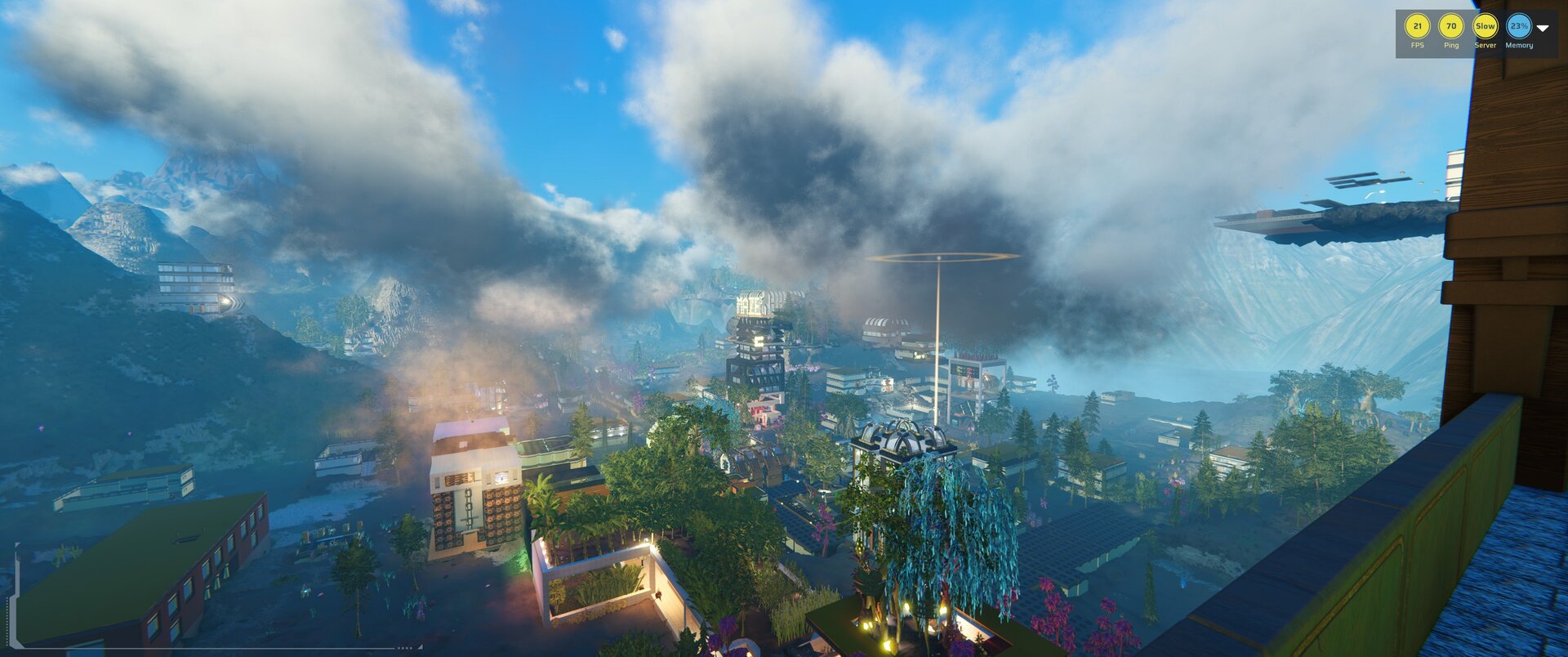 A player-built city among trees and mountains beneath drifting clouds. Screenshot courtesy of LDP.